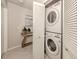 Convenient laundry area with a stacked washer and dryer, featuring extra storage space at 800 Gardens Edge Dr # 814, Venice, FL 34285