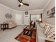 Comfortable living room with tile floors, neutral walls, ceiling fan, and an area rug at 800 Gardens Edge Dr # 814, Venice, FL 34285