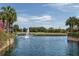 Picturesque pond with a water fountain and surrounding landscaping at 800 Gardens Edge Dr # 814, Venice, FL 34285
