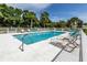 Serene community pool with lounge chairs, perfect for enjoying sunny days at 800 Gardens Edge Dr # 814, Venice, FL 34285