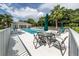 Lovely pool area surrounded by lush greenery, featuring tables and seating for residents at 800 Gardens Edge Dr # 814, Venice, FL 34285