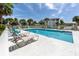 Beautiful community pool with sun loungers and clear blue water, perfect for recreation at 800 Gardens Edge Dr # 814, Venice, FL 34285
