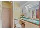Compact bathroom features a shower, toilet, vanity, and decorative accents at 8155 Mossborger Ave, North Port, FL 34287