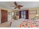 Comfortable bedroom with a ceiling fan, view to bathroom, and classic furnishings at 8155 Mossborger Ave, North Port, FL 34287