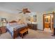 Comfortable bedroom with a ceiling fan, classic furnishings, and plenty of wall art at 8155 Mossborger Ave, North Port, FL 34287