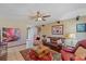 Cozy living room featuring tile floors, comfortable seating, and a ceiling fan at 8155 Mossborger Ave, North Port, FL 34287