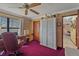 Well-organized office space with a large desk, wardrobe, and ample natural light at 8155 Mossborger Ave, North Port, FL 34287