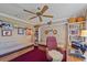 Cozy office space with a ceiling fan, built-in shelves, and a comfortable seating area at 8155 Mossborger Ave, North Port, FL 34287