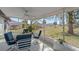 Enclosed patio with a ceiling fan and comfortable seating, perfect for outdoor dining at 8155 Mossborger Ave, North Port, FL 34287