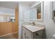 Neat bathroom with a white vanity, neutral countertops and a well-lit mirror at 822 Capri Isles Blvd # 210, Venice, FL 34292