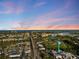 Scenic aerial view of the city skyline, ocean, and a water tower against a beautiful sunset backdrop at 929 The Rialto, Venice, FL 34285