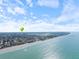 Expansive aerial view of the coastline showing stunning oceanfront property with a nearby airfield and city at 929 The Rialto, Venice, FL 34285