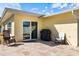 Outdoor patio with a grill, lounge chair, and seating, perfect for entertaining or relaxing outside at 929 The Rialto, Venice, FL 34285
