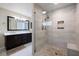 Bathroom featuring a seamless glass shower and neutral colored stone tile at 929 The Rialto, Venice, FL 34285
