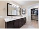 Well-lit bathroom featuring a dark wood vanity, quartz countertops, and a large mirror at 929 The Rialto, Venice, FL 34285