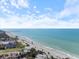 Stunning beachside property with a long pier and a row of charming houses along the shoreline at 929 The Rialto, Venice, FL 34285