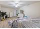 Spacious bedroom featuring a bed, dresser, and open doorway, with a ceiling fan at 929 The Rialto, Venice, FL 34285