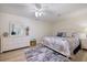 Cozy bedroom with a queen bed, white dresser, and beach-themed decor at 929 The Rialto, Venice, FL 34285