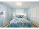 Comfortable blue bedroom with white curtains and seashell pattern comforter at 929 The Rialto, Venice, FL 34285