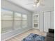 Bonus room with wood-look floors, large windows with blinds, a closet, and a comfortable seating area at 929 The Rialto, Venice, FL 34285