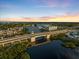 Picturesque view of a bridge over tranquil waters at sunset, with boats docked and buildings nearby at 929 The Rialto, Venice, FL 34285