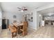Bright dining room with a wooden table, stylish chairs, and a view into the kitchen at 929 The Rialto, Venice, FL 34285