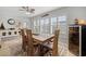 Sunlit dining room features plantation shutters, ceiling fan, and wine cooler at 929 The Rialto, Venice, FL 34285