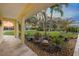 View from the covered porch overlooking the meticulously maintained front yard and verdant tropical landscaping at 929 The Rialto, Venice, FL 34285