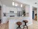 Bright kitchen with a center island with barstool seating and modern appliances at 929 The Rialto, Venice, FL 34285