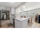 Charming kitchen with stainless steel appliances, marble countertop island, and a view of the dining area at 929 The Rialto, Venice, FL 34285