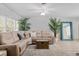 Inviting living room with a plush sectional sofa, natural light, and modern decor at 929 The Rialto, Venice, FL 34285