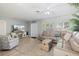 Open-concept living room featuring a comfortable sectional sofa, a stylish trunk coffee table, and an entertainment center at 929 The Rialto, Venice, FL 34285