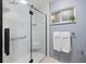 Modern shower features a glass enclosure, marble tile, and a hand held fixture at 929 The Rialto, Venice, FL 34285