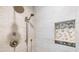 Modern shower with a rainfall shower head, neutral toned tile, and a built-in niche at 929 The Rialto, Venice, FL 34285