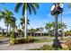 Picturesque street view lined with palm trees and charming buildings on a sunny day at 929 The Rialto, Venice, FL 34285