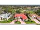 High angle showcases this beautiful single-Gathering home with a red roof in a lushly landscaped community at 945 Chickadee Dr, Venice, FL 34285