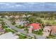 Aerial shot showcases this beautiful single-Gathering home with a red roof in a lushly landscaped community at 945 Chickadee Dr, Venice, FL 34285