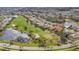 Aerial view of a golf course community with mature trees at 945 Chickadee Dr, Venice, FL 34285