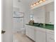 Bathroom with a glass shower, and vanity with white cabinets and a green countertop at 945 Chickadee Dr, Venice, FL 34285