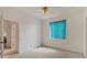 Spacious bedroom with a ceiling fan, carpet flooring, and a window with turquoise blinds at 945 Chickadee Dr, Venice, FL 34285