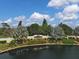 Beautiful gated entrance to Pelican Pointe Golf and Country Club with lush landscaping and water feature at 945 Chickadee Dr, Venice, FL 34285