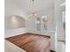 Bright dining room with hardwood floors, chandelier, and large windows at 945 Chickadee Dr, Venice, FL 34285