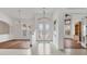 Bright foyer featuring tile flooring, a chandelier, and a beautiful view into other rooms at 945 Chickadee Dr, Venice, FL 34285