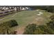 Scenic golf course aerial view showcasing lush green fairways, sand traps, and serene waterfront at 945 Chickadee Dr, Venice, FL 34285