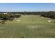 Aerial view of the golf course driving range with multiple hitting locations for golfers at 945 Chickadee Dr, Venice, FL 34285