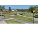Scenic golf course view with lush greenery, palm trees and winding cart paths at 945 Chickadee Dr, Venice, FL 34285