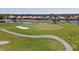 Aerial shot of golf course putting green with ponds, bunkers, and palm trees at 945 Chickadee Dr, Venice, FL 34285