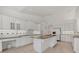 Bright kitchen with white cabinets, granite countertops, and tile flooring at 945 Chickadee Dr, Venice, FL 34285