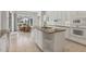 Bright kitchen featuring granite counters, white cabinets, and an island at 945 Chickadee Dr, Venice, FL 34285