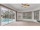Bright living room with large sliding glass doors providing access to the screened pool area at 945 Chickadee Dr, Venice, FL 34285